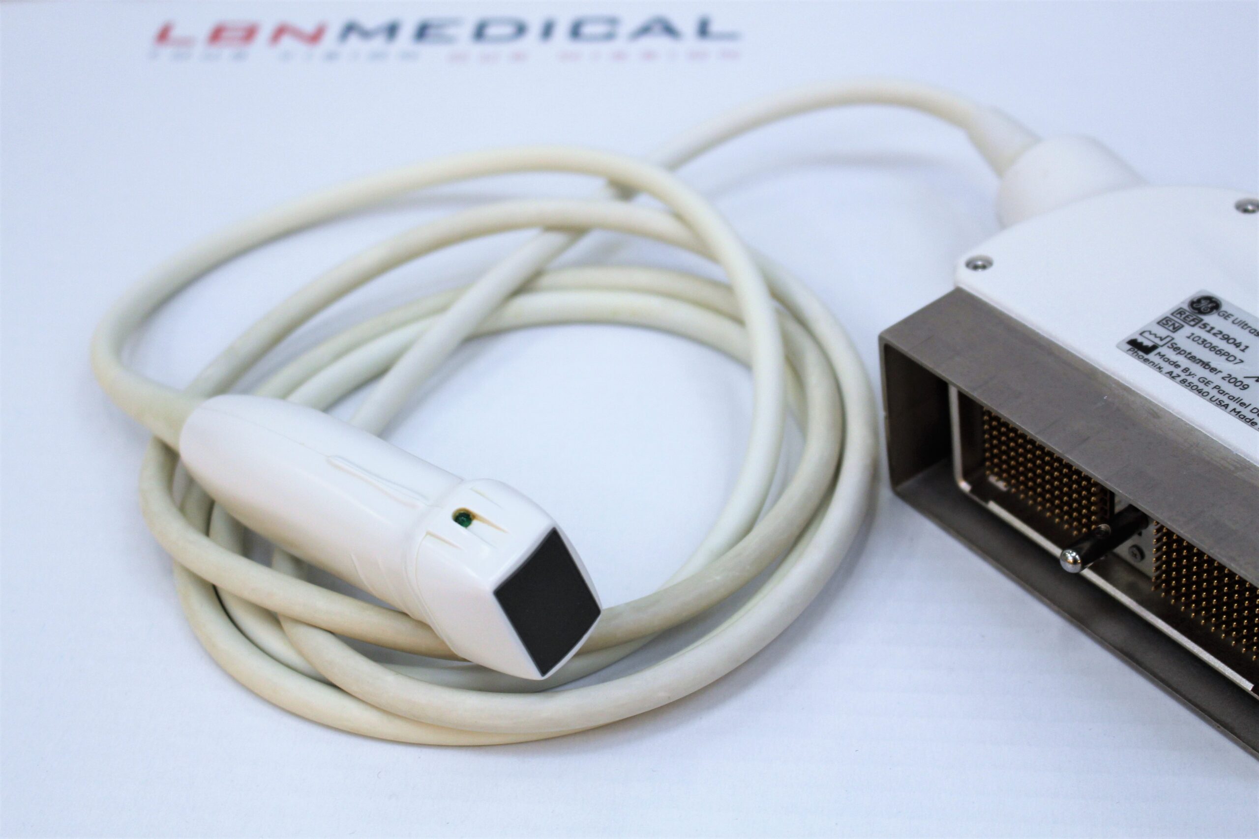 ultrasound transducer types - Phased Array Transducer. Close-up of a phased array ultrasound probe, showing the compact, rectangular transducer head and coiled cable. Phased array ultrasound probe, designed for cardiac imaging and detailed visualization of the heart and blood flow. LBN Medical.