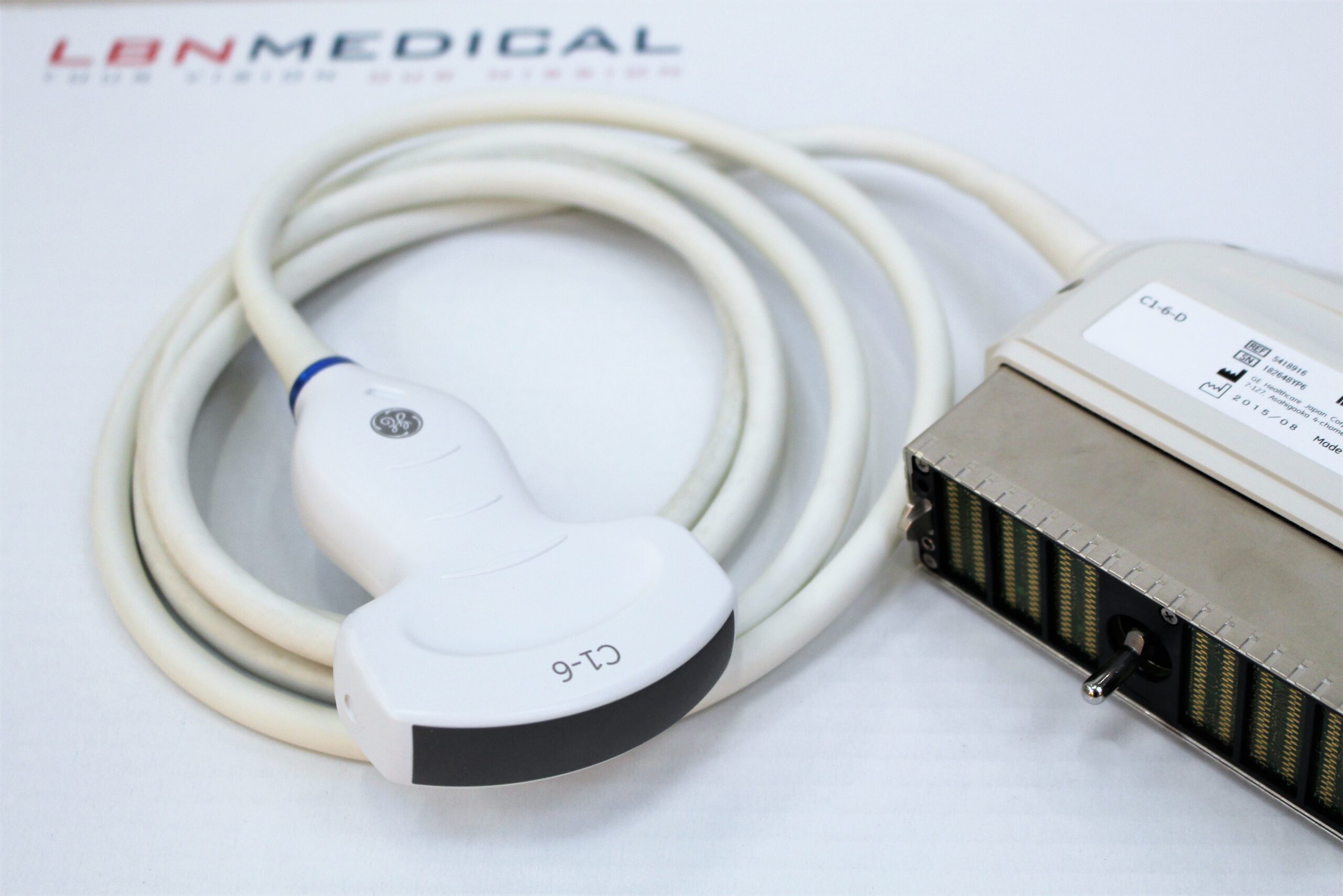 convex transducer - GE C1 - 6 - curvilinear probe. GE C1-6-D convex ultrasound probe, used for abdominal and obstetric imaging, shown with its connector and coiled cable. Provided by LBN Medical.