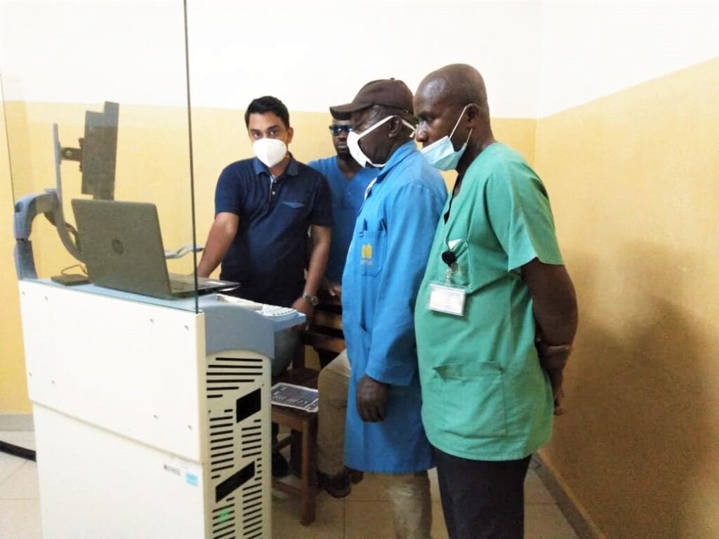 Happy Cameroonian customers looking at the viewing station for the mammography machine. DirectMed Imaging.